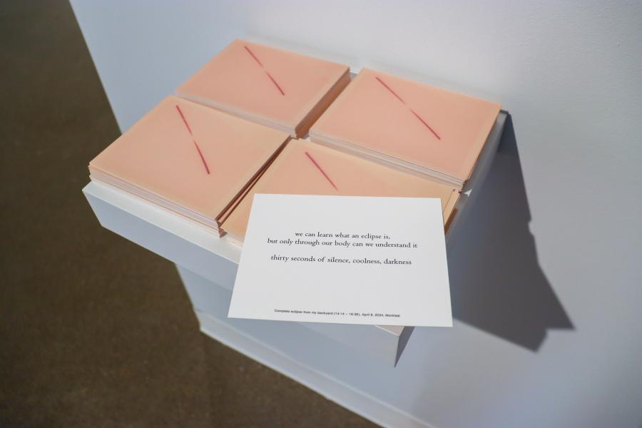 Stack of prints titled "Eclipse from my backyard," paired with a poetic text reflecting on the sensory experience of an eclipse.