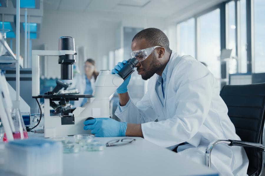 Man looking into a microscope.