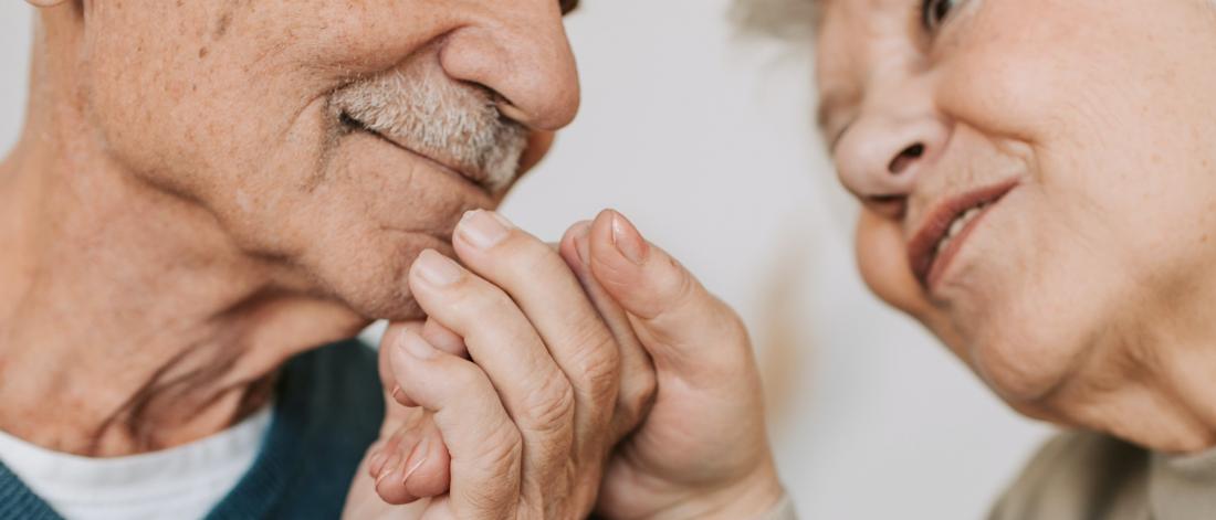 Elderly couple holding hands.
