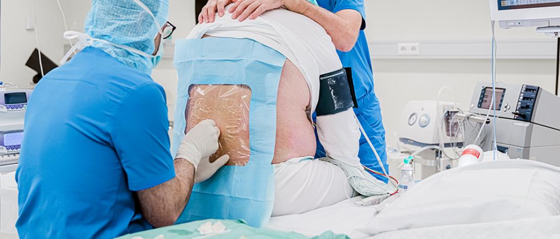 Anesthesiologist doing a spinal block epidural on a patient just before the operation. Doctor giving anesthesia into the back a patient before the surgery.