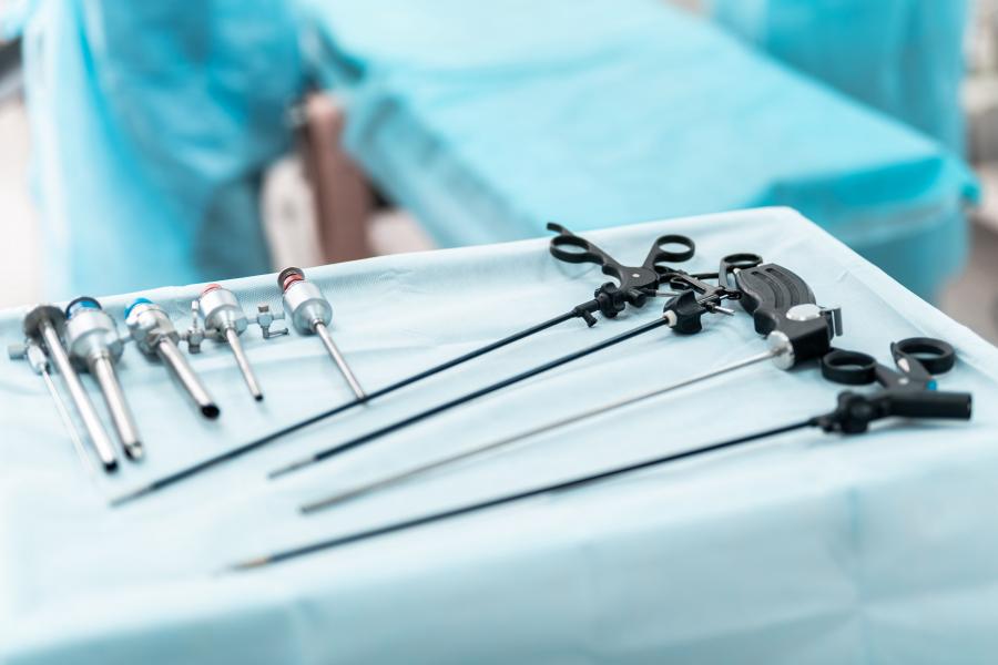 Preparation for surgery. Close up of white table with laparoscopic tools, scissors, trocars and cannulas