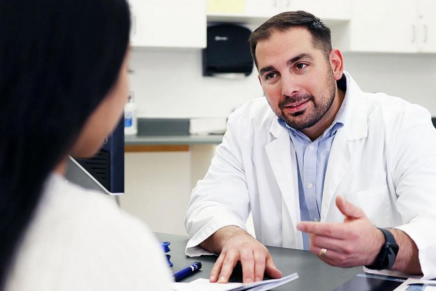 Pharmacist meeting with a patient.
