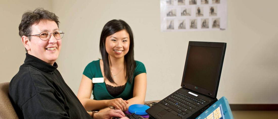 Two rehabilitation sciences researchers sitting at a table together.