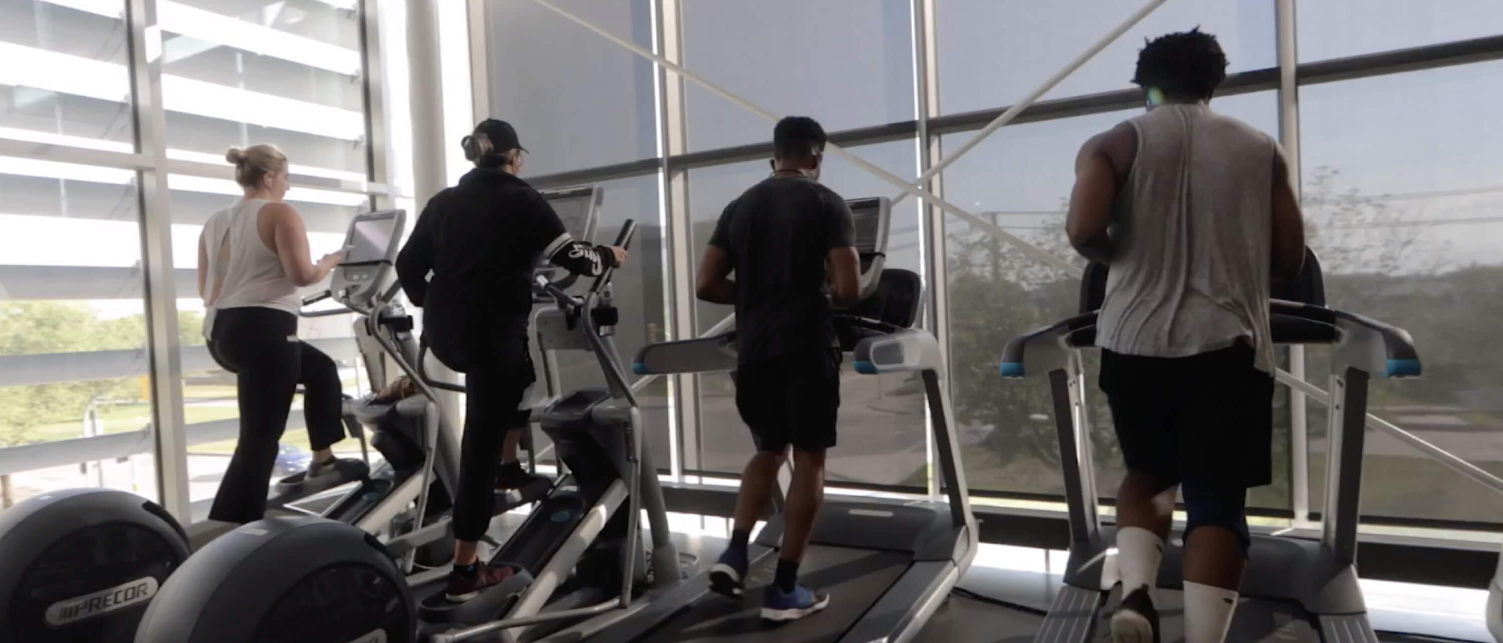 Four Active Living Centre members run on treadmills.